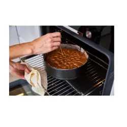 A woman baking a cake.