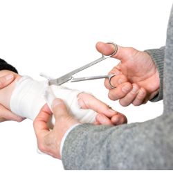 A surgeon using bandage scissors