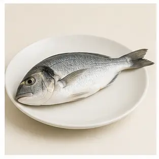 A whole fish on a plate for English food vocabulary learners.