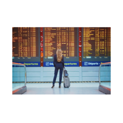 A girl looking for flight information at a flight screen