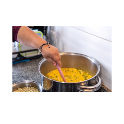 A woman stirring soup.