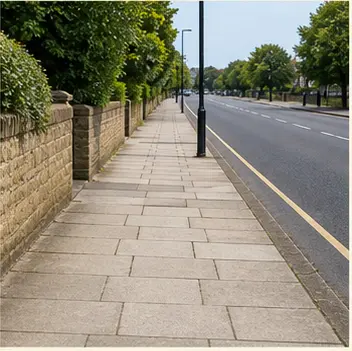 A realistic vocabulary image showing a pavement beside a road.